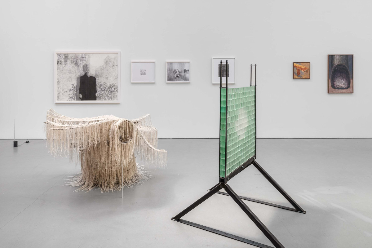 Installation view with sculpture and framed drawings
