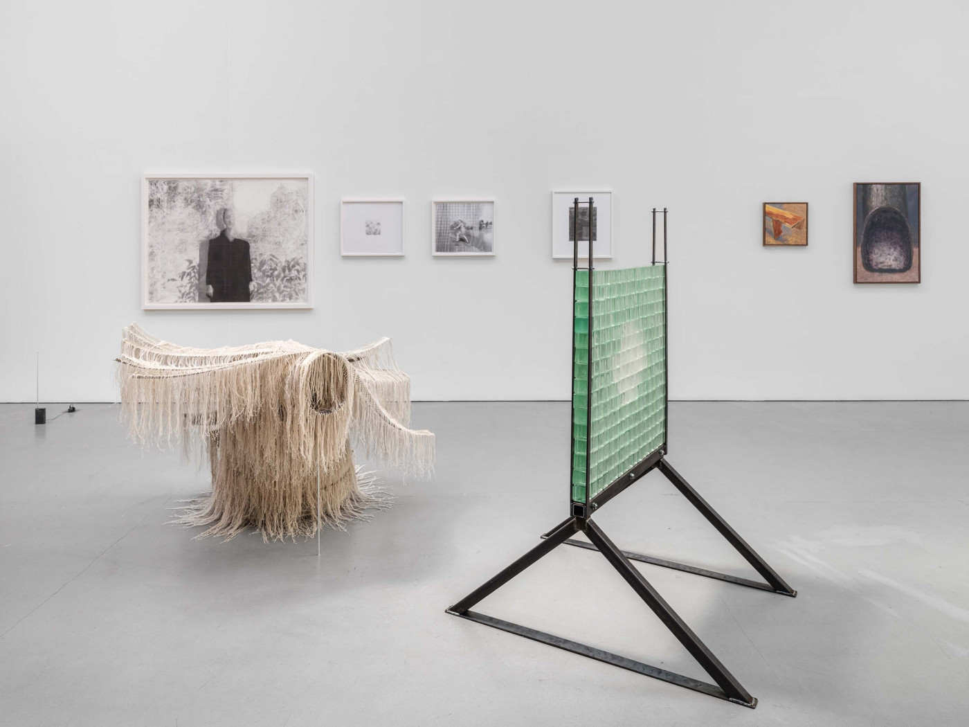 Installation view with sculpture and framed drawings